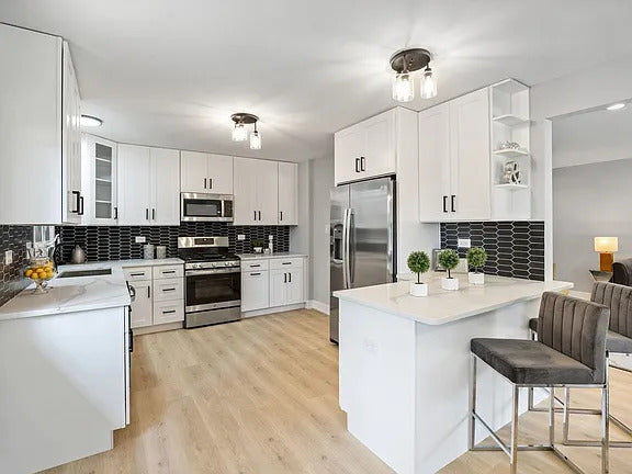 Maximize Storage With White Cabinets and Black Backsplash in Addison, IL