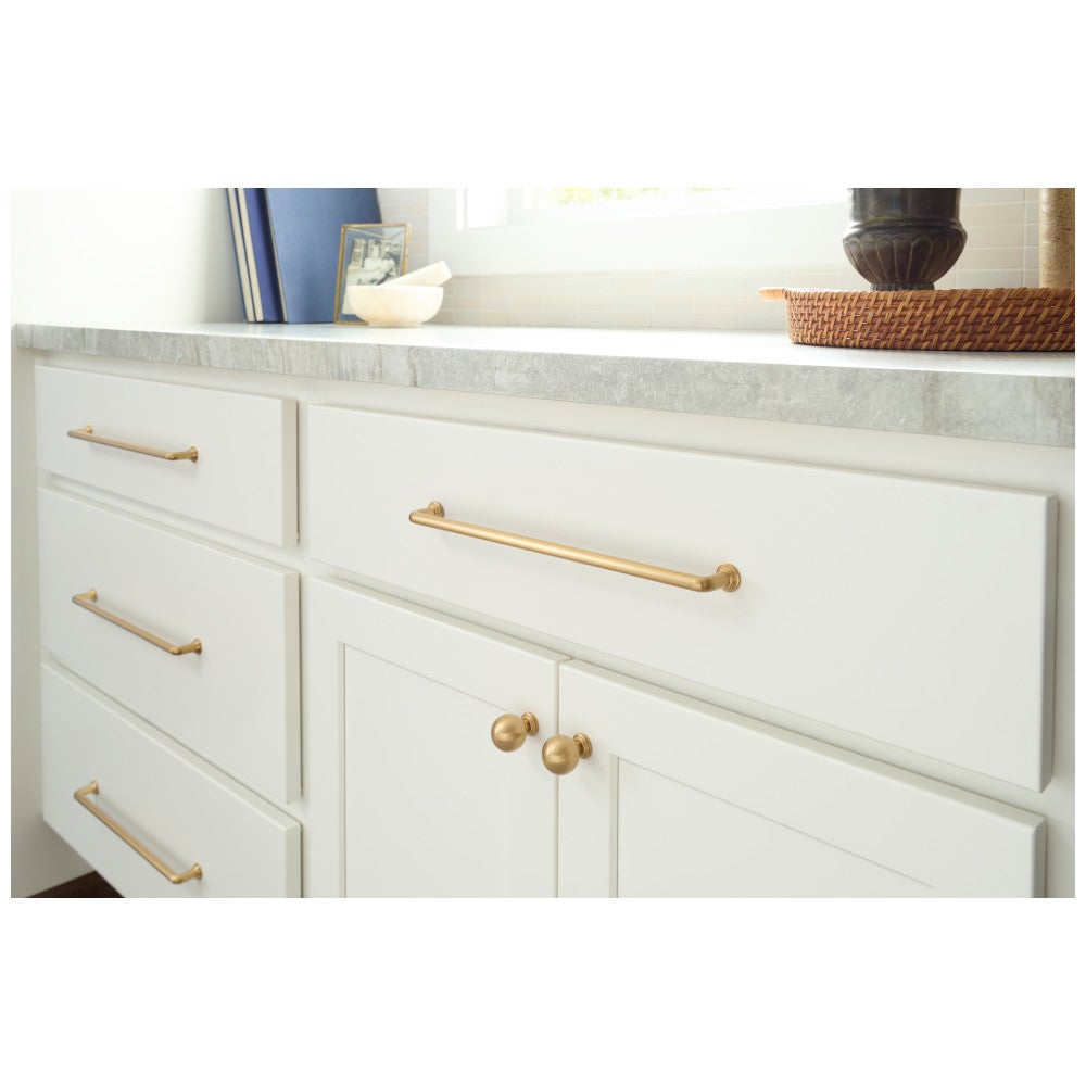 Brushed gold pulls on white kitchen cabinets